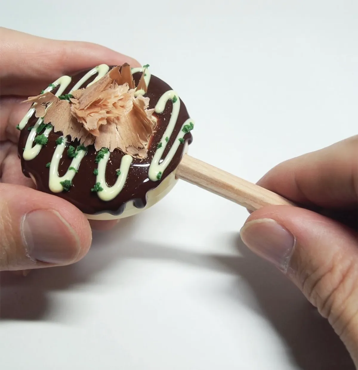 A pencil sharpener shaped like a takoyaki whose pencil shavings turn into bonito flakes.